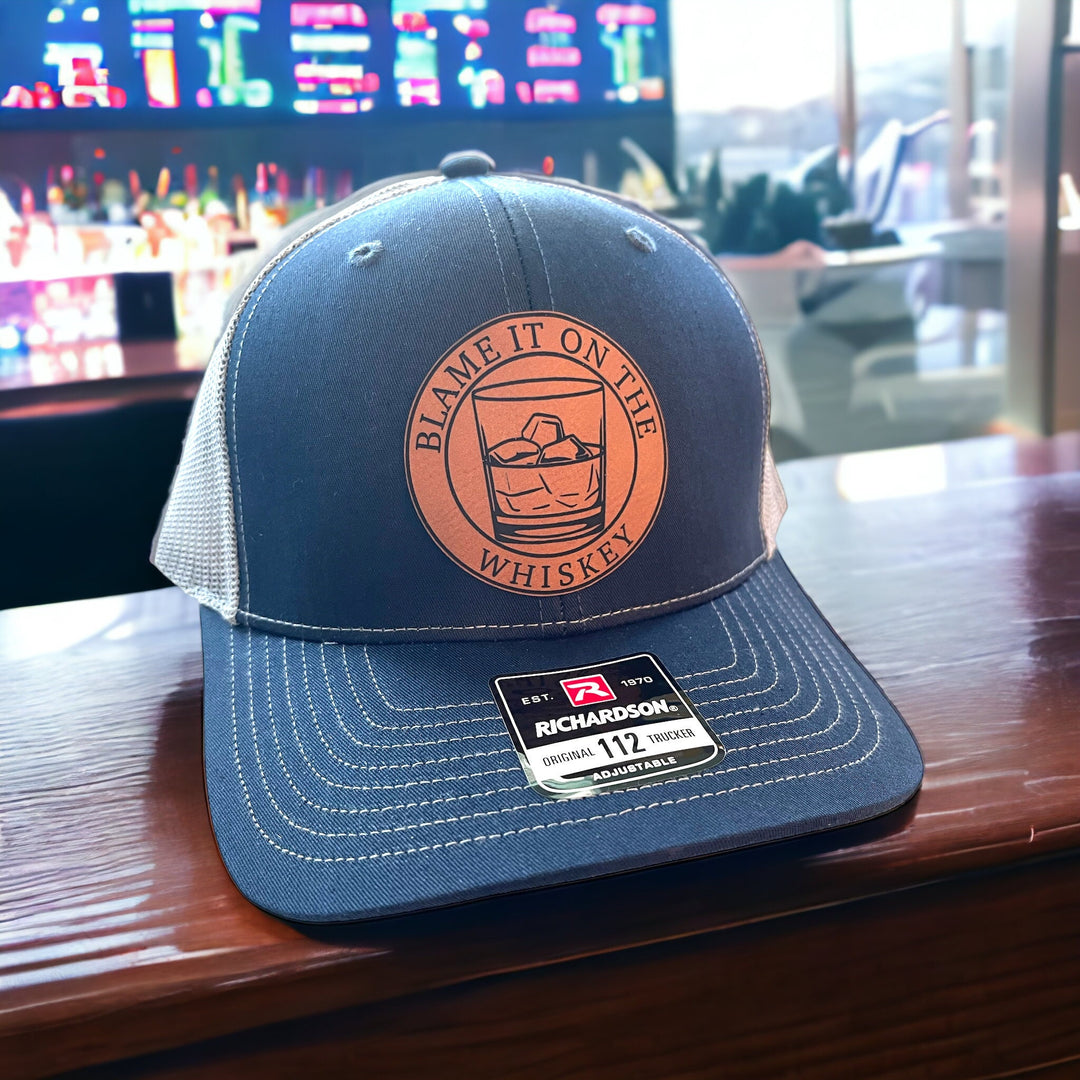 Blame It On The Whiskey leatherette patch trucker hat by BubbleHead Ink
