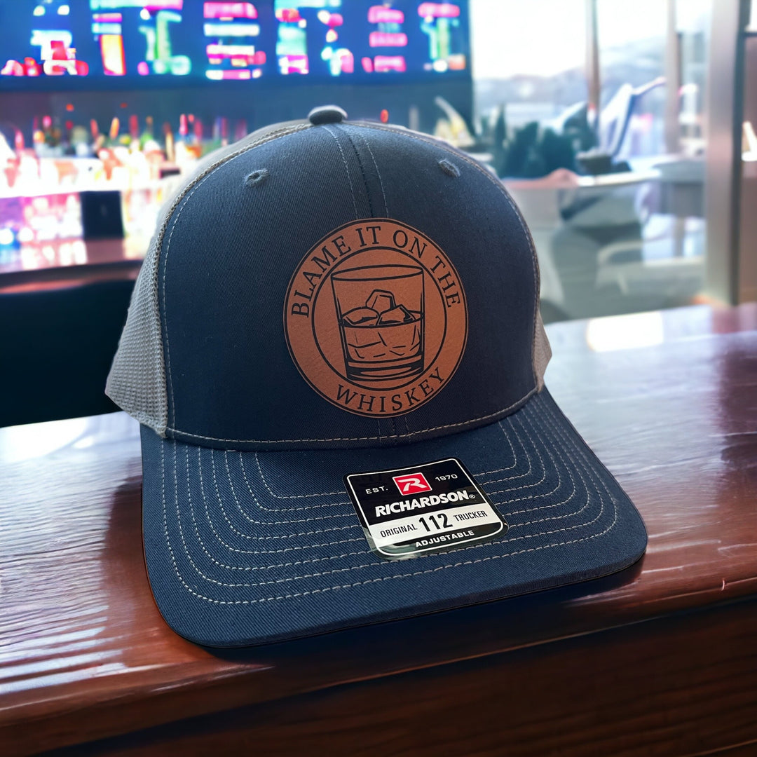 Blame It On The Whiskey leatherette patch trucker hat by BubbleHead Ink