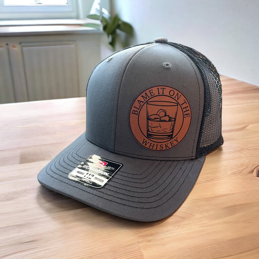 Blame It On The Whiskey leatherette patch trucker hat by BubbleHead Ink
