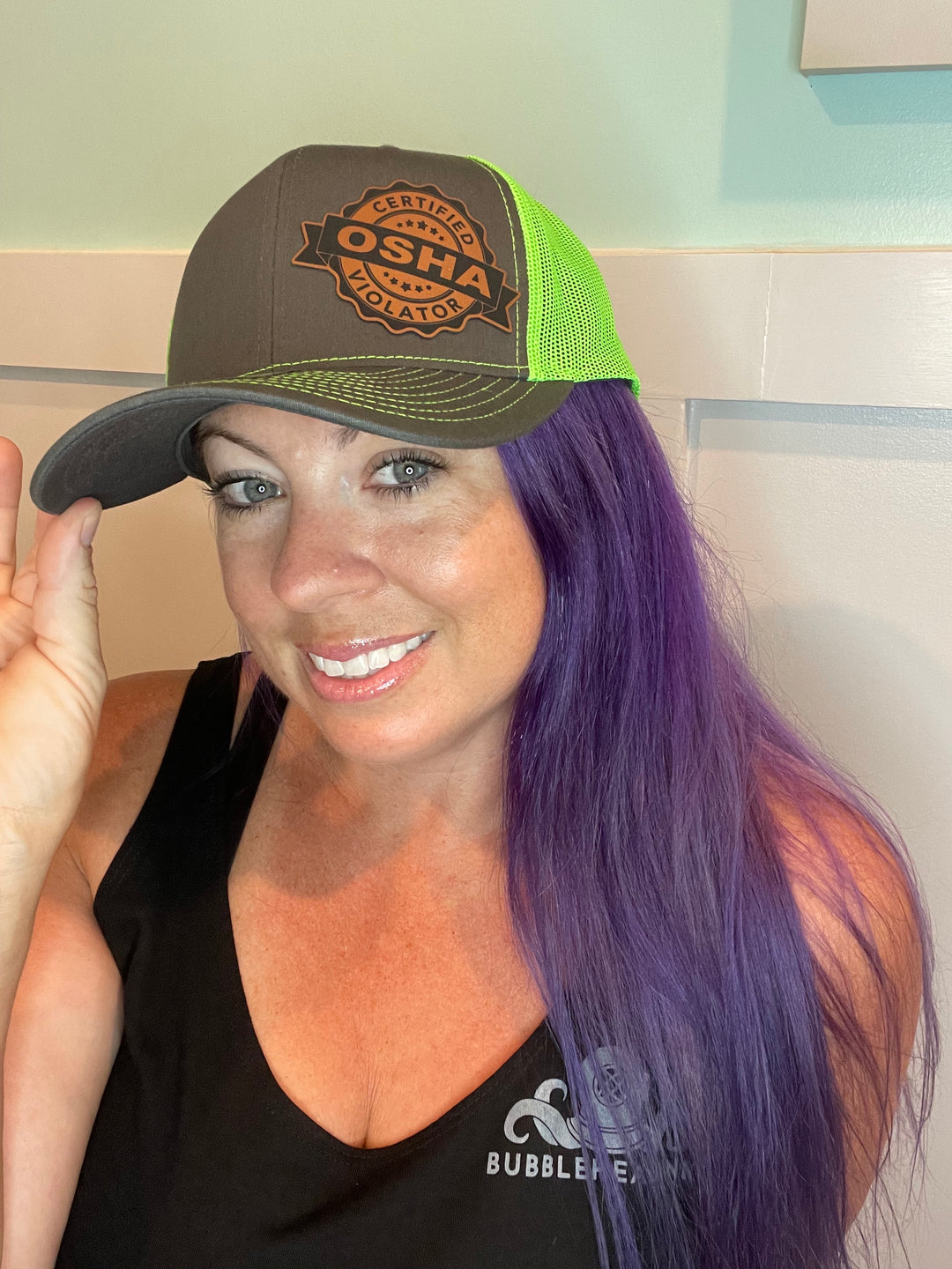 Certified OSHA Violator trucker hat in green, side view, by BubbleHead Ink