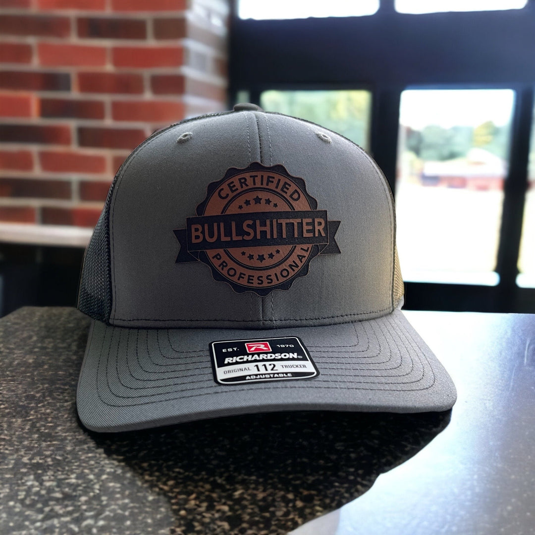 Certified Professional Bullshitter funny trucker hat with leather patch by BubbleHead Ink