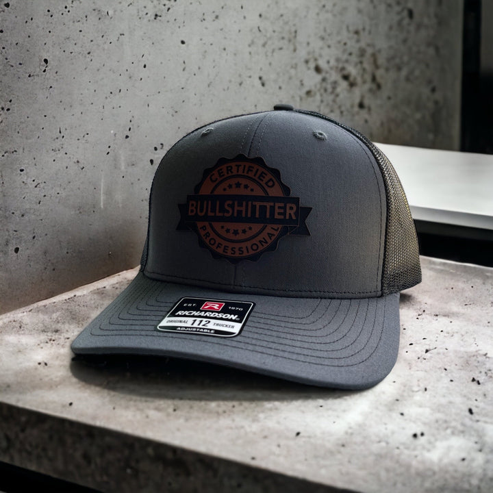 Certified Professional Bullshitter funny trucker hat with leather patch by BubbleHead Ink