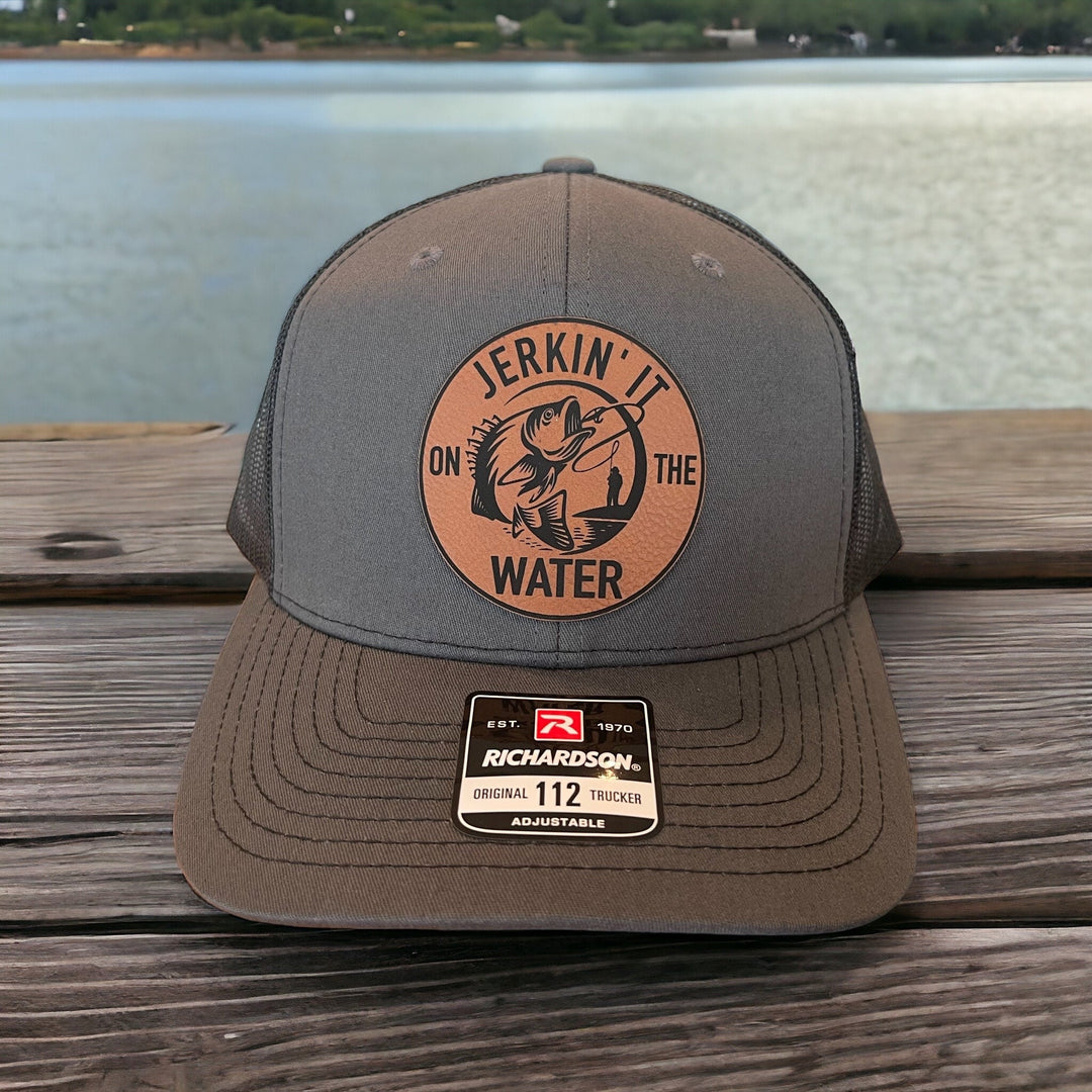 Jerkin' It On The Water funny bass fishing trucker hat by BubbleHead Ink