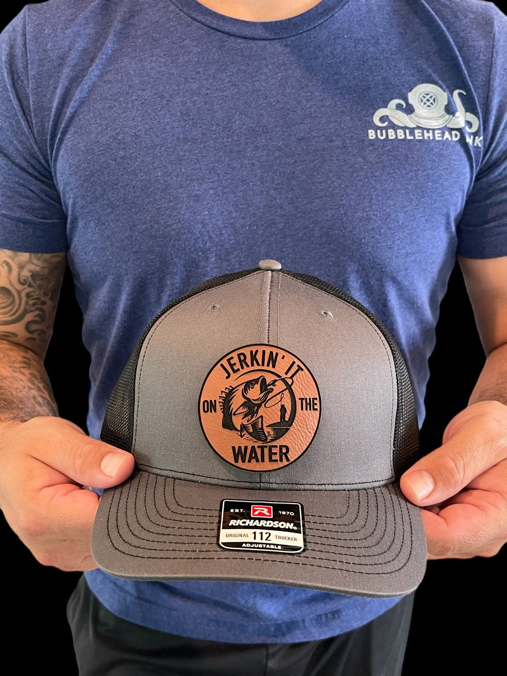 Jerkin' It On The Water funny bass fishing trucker hat by BubbleHead Ink