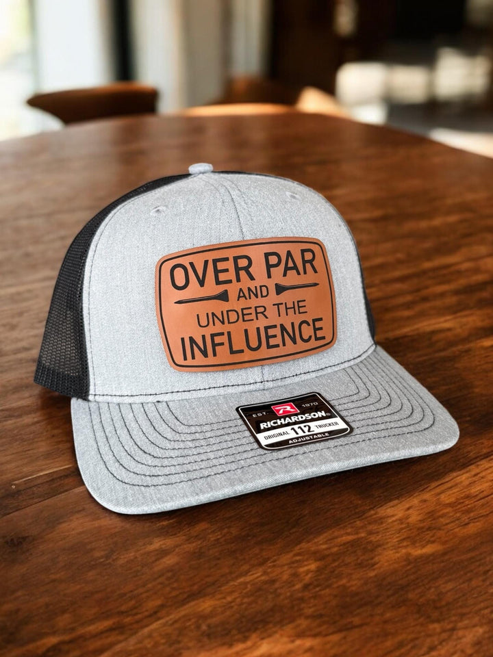 Over Par and Under the Influence funny golf trucker hat by BubbleHead Ink