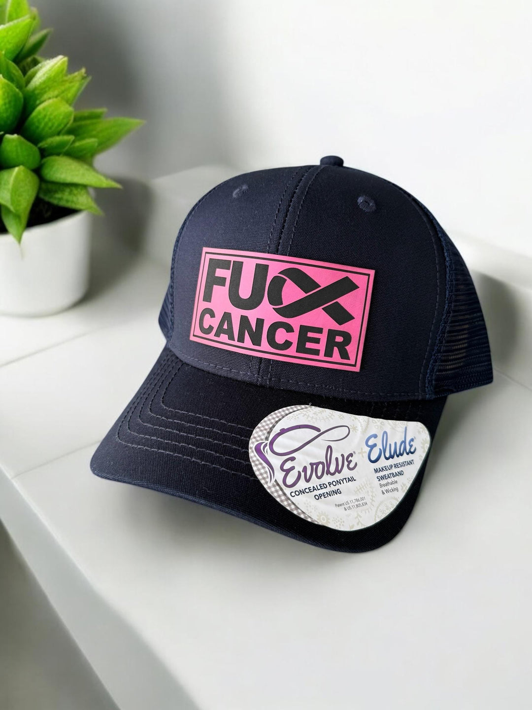 Pink ribbon breast cancer women's navy ponytail trucker hat by BubbleHead Ink