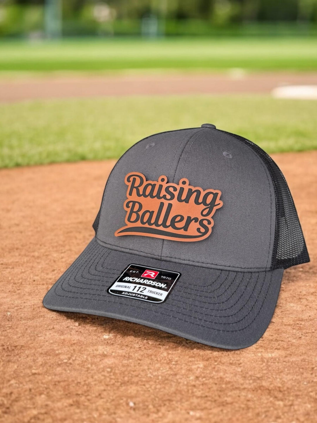 Raising Ballers baseball and football dad trucker hat by BubbleHead Ink