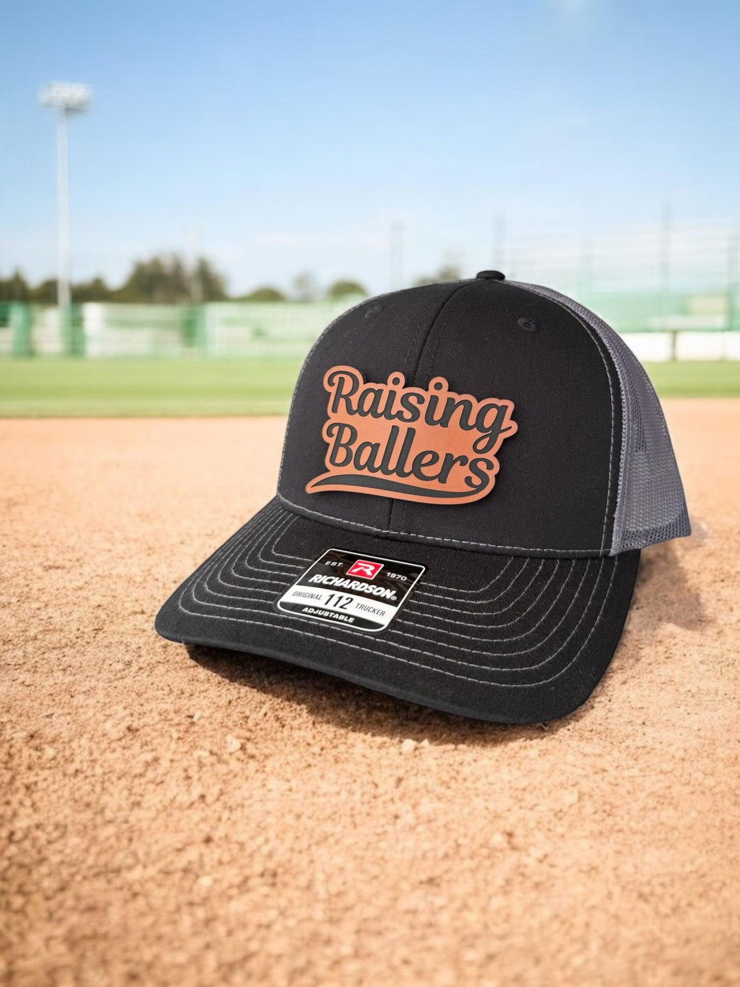 Raising Ballers baseball and football dad trucker hat by BubbleHead Ink