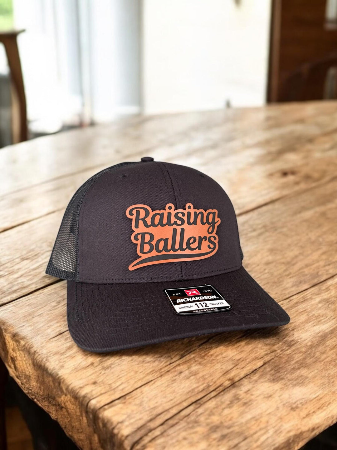 Raising Ballers baseball and football dad trucker hat by BubbleHead Ink