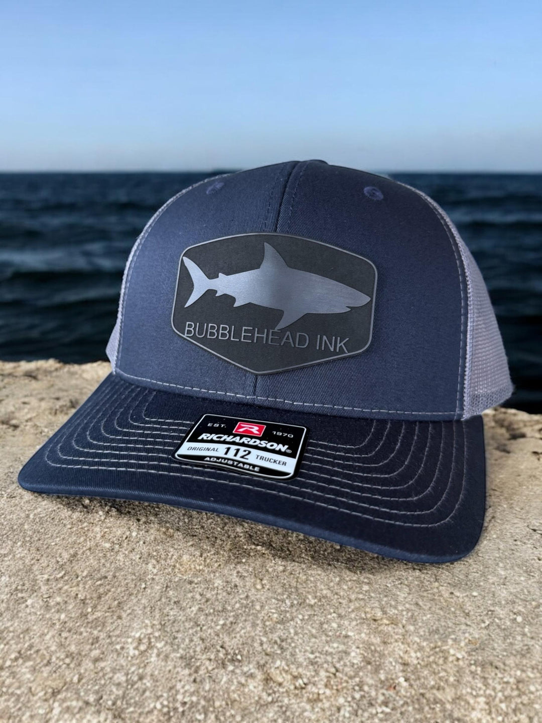 Shark silhouette BubbleHead Ink patch Richardson 112 trucker hat