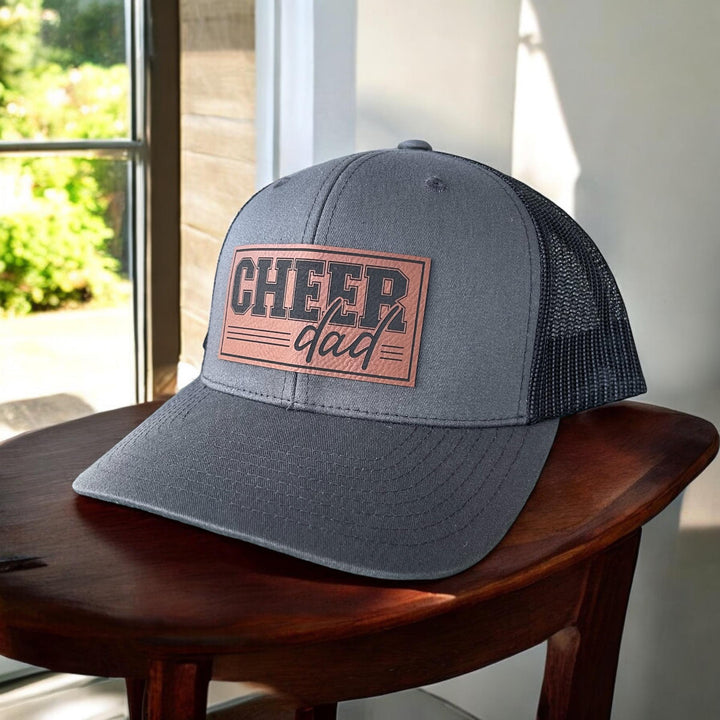 Show your cheer pride with the Cheer Dad Trucker Hat. Durable structured front with adjustable snapback for a perfect fit.